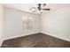 Bedroom with a ceiling fan, window, and light hardwood floors at 26956 N 83Rd Gln, Peoria, AZ 85383