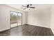 Bedroom with a sliding glass door to a patio, ceiling fan, and sleek wood floors at 26956 N 83Rd Gln, Peoria, AZ 85383
