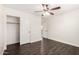 Bedroom with hardwood floors, closet, ceiling fan, and neutral paint at 26956 N 83Rd Gln, Peoria, AZ 85383