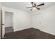 Bedroom featuring hardwood floors, a ceiling fan, and access to a closet at 26956 N 83Rd Gln, Peoria, AZ 85383