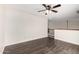 Upstairs bonus room featuring wood floors, neutral walls, and a ceiling fan at 26956 N 83Rd Gln, Peoria, AZ 85383