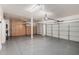 A large garage with epoxy floors and custom storage cabinets at 26956 N 83Rd Gln, Peoria, AZ 85383