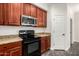 Modern kitchen features a stainless steel microwave and black range with ample cabinet space at 26956 N 83Rd Gln, Peoria, AZ 85383