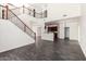 Spacious living room featuring high ceilings, open staircase, and wood look flooring at 26956 N 83Rd Gln, Peoria, AZ 85383