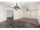 Spacious living room with wood floors, neutral carpet, and an elegant chandelier at 26956 N 83Rd Gln, Peoria, AZ 85383
