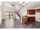 Light filled room boasting a fan, staircase, kitchen pass-through, and elegant flooring at 26956 N 83Rd Gln, Peoria, AZ 85383