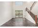 Open living space with backyard view, staircase, and seamless flooring throughout at 26956 N 83Rd Gln, Peoria, AZ 85383