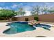 Beautiful in-ground pool with spa, rock waterfall and ample tanning deck space at 26956 N 83Rd Gln, Peoria, AZ 85383