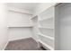 Well-organized walk-in closet with shelves and hanging rods for ample storage at 26956 N 83Rd Gln, Peoria, AZ 85383