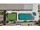 Aerial view of the backyard featuring a swimming pool, spa, and putting green at 28093 N Pasture Canyon Dr, San Tan Valley, AZ 85143