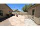 Spacious backyard patio with a fire pit, desert landscaping, and block fence at 28093 N Pasture Canyon Dr, San Tan Valley, AZ 85143