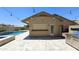 Outdoor kitchen with stainless steel appliances and a covered bar area next to the pool at 28093 N Pasture Canyon Dr, San Tan Valley, AZ 85143