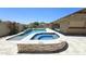 Luxurious pool and spa area with a built-in water feature, stone accents, and patio space at 28093 N Pasture Canyon Dr, San Tan Valley, AZ 85143
