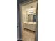 Bathroom with tile floors, double sinks, large mirror, and white cabinets at 28093 N Pasture Canyon Dr, San Tan Valley, AZ 85143