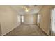 Spacious bedroom featuring neutral paint, large windows, a ceiling fan, and plush carpeting at 28093 N Pasture Canyon Dr, San Tan Valley, AZ 85143