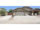Exterior view showcasing a two-car garage, extended driveway, and well-kept facade at 28093 N Pasture Canyon Dr, San Tan Valley, AZ 85143