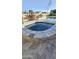 Inviting hot tub featuring stone surround and nearby swimming pool, perfect for relaxation at 28093 N Pasture Canyon Dr, San Tan Valley, AZ 85143