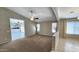 Spacious living room with carpeted floors, ceiling fan, and natural light, perfect for relaxing and entertaining at 28093 N Pasture Canyon Dr, San Tan Valley, AZ 85143