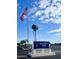 Saguaro Sun community entrance featuring a welcoming sign under a beautiful sky with palm trees and an American flag at 305 S Val Vista Dr # 243, Mesa, AZ 85204