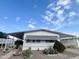 Well maintained manufactured home with desert landscaping, covered parking, and plenty of sunshine at 305 S Val Vista Dr # 243, Mesa, AZ 85204