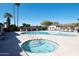 Hot tub with clear blue water and bubbling jets next to a community pool at 305 S Val Vista Dr # 243, Mesa, AZ 85204