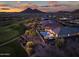 Sunset aerial view highlighting the backyard pool, patio, desert landscape, and adjacent golf course at 31108 N 122Nd Ln, Peoria, AZ 85383