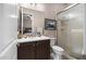 Well-lit bathroom features a modern vanity, framed art, a glass enclosed shower, and neutral walls at 31108 N 122Nd Ln, Peoria, AZ 85383