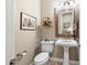 Powder room features a pedestal sink, a modern toilet, and decorative accents at 31108 N 122Nd Ln, Peoria, AZ 85383