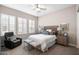 Cozy bedroom features a queen size bed, neutral walls, plantation shutters, and comfortable seating at 31108 N 122Nd Ln, Peoria, AZ 85383