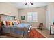 Comfortable bedroom features decorative pillows, a wooden bed frame, and bright windows with decorative shutters at 31108 N 122Nd Ln, Peoria, AZ 85383