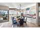 Open-concept dining area flows to outdoor living area and has views of wet bar and living area at 31108 N 122Nd Ln, Peoria, AZ 85383