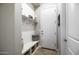 Bright mudroom features a built-in bench, shelving, a coat rack, and tile flooring at 31108 N 122Nd Ln, Peoria, AZ 85383