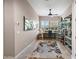 Bright office features an area rug, desk, ceiling fan, and bright windows with decorative shutters at 31108 N 122Nd Ln, Peoria, AZ 85383
