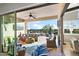 Covered patio features an outdoor lounge area, pool, and views of the backyard oasis at 31108 N 122Nd Ln, Peoria, AZ 85383
