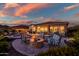 Backyard patio featuring a cozy fire pit with comfortable seating, perfect for outdoor entertaining at sunset at 31108 N 122Nd Ln, Peoria, AZ 85383