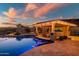 Outdoor kitchen and swim up bar with seating and a beautiful pool, ideal for outdoor gatherings at 31108 N 122Nd Ln, Peoria, AZ 85383