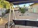 View of the backyard with a swing set, greenery, statues, and desert landscaping at 3231 N 81St Pl, Scottsdale, AZ 85251