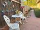 Cozy backyard seating area with ornate metal furniture, brick patio, and colorful accents at 3231 N 81St Pl, Scottsdale, AZ 85251