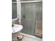 Bathroom features a pedestal sink and tiled shower with glass doors and a towel rack at 3231 N 81St Pl, Scottsdale, AZ 85251