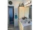 Bathroom features a sink with cabinet, mirror, lighting and a view of the shower and patterned blue curtain at 3231 N 81St Pl, Scottsdale, AZ 85251