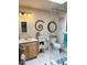 Bathroom with a glass shower door, natural-colored tile, and vanity with storage at 3231 N 81St Pl, Scottsdale, AZ 85251