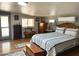 Bedroom boasts hardwood floors, dresser, bench, and a bed with black and white patterned bedding at 3231 N 81St Pl, Scottsdale, AZ 85251