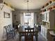 Traditional dining room with large window, chandelier, hardwood floors, and decorative hutch at 3231 N 81St Pl, Scottsdale, AZ 85251