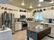 Open kitchen featuring stainless steel appliances, gray countertops, and white cabinets with ample storage space at 3231 N 81St Pl, Scottsdale, AZ 85251