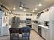 Spacious kitchen boasts stainless steel appliances, ample cabinet space, and a large island with barstools at 3231 N 81St Pl, Scottsdale, AZ 85251