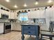 Bright kitchen featuring white cabinets, stainless steel appliances, and a center island with seating at 3231 N 81St Pl, Scottsdale, AZ 85251