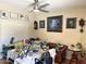 Comfortable living room with a leather couch, art and a fan, and a lot of art supplies at 3231 N 81St Pl, Scottsdale, AZ 85251
