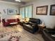Inviting living room featuring a red sofa, black recliners, natural light, and stylish decor at 3231 N 81St Pl, Scottsdale, AZ 85251