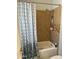 Tiled shower with mixed pattern tile surround features a shower caddy and shower curtain rod at 3231 N 81St Pl, Scottsdale, AZ 85251