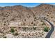 Desert homesite with paved road winding up to a custom luxury residence on the hillside at 3284 W Highlands Dr, Buckeye, AZ 85396